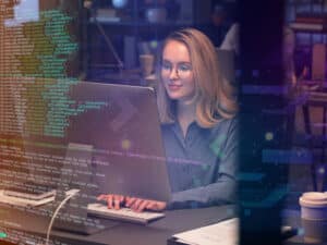 Woman working on a laptop, writing code | BetterSoftware